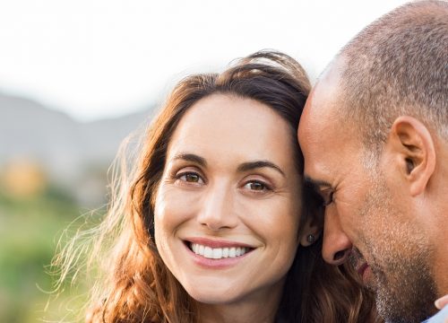 Middle-age couple with sagging skin hugging each other