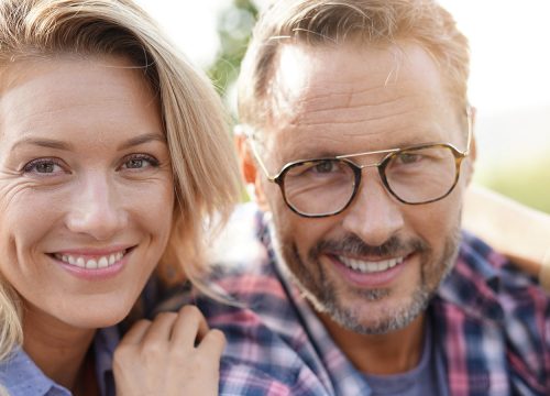 Happy older couple with facial scars